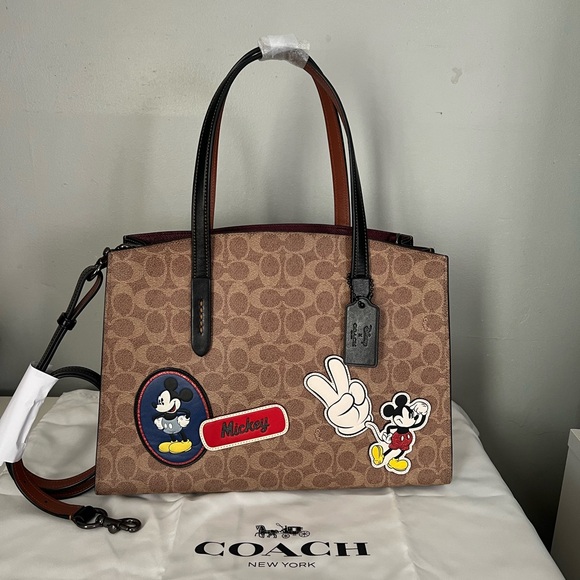 Coach Handbags - Disney X Coach Charlie Carryall
In Signature Canvas With Patches